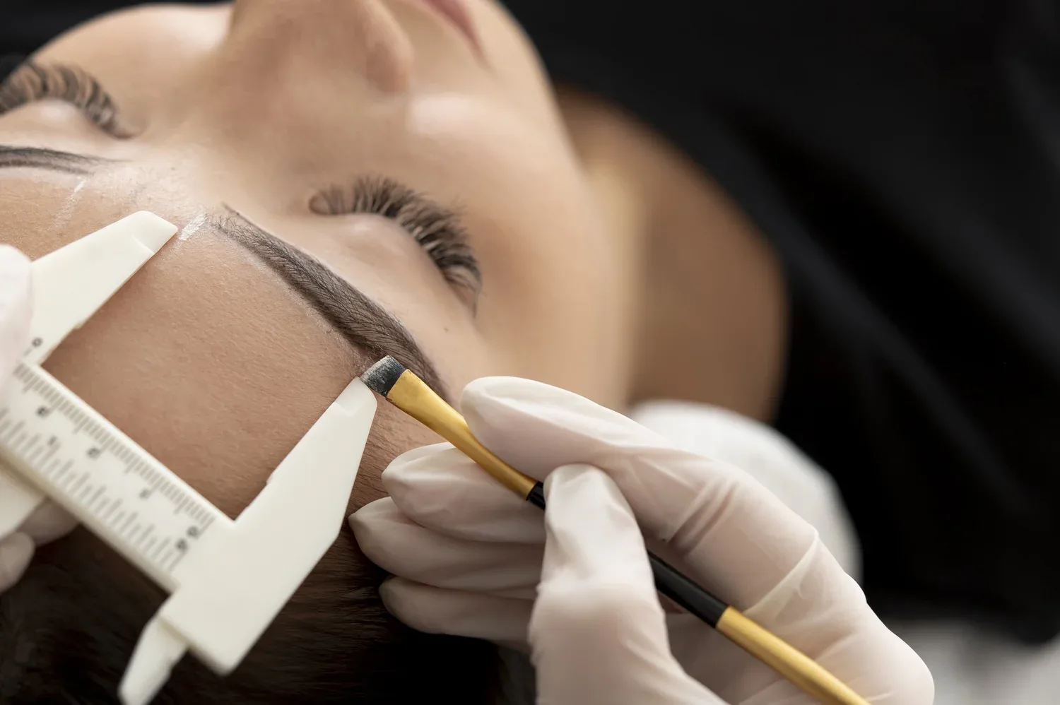 Brow mapping — precise caliper measurement before tattooing