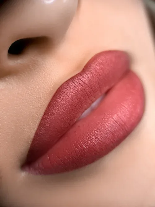 Healed lip blush result — luminous mauve-pink lips macro
