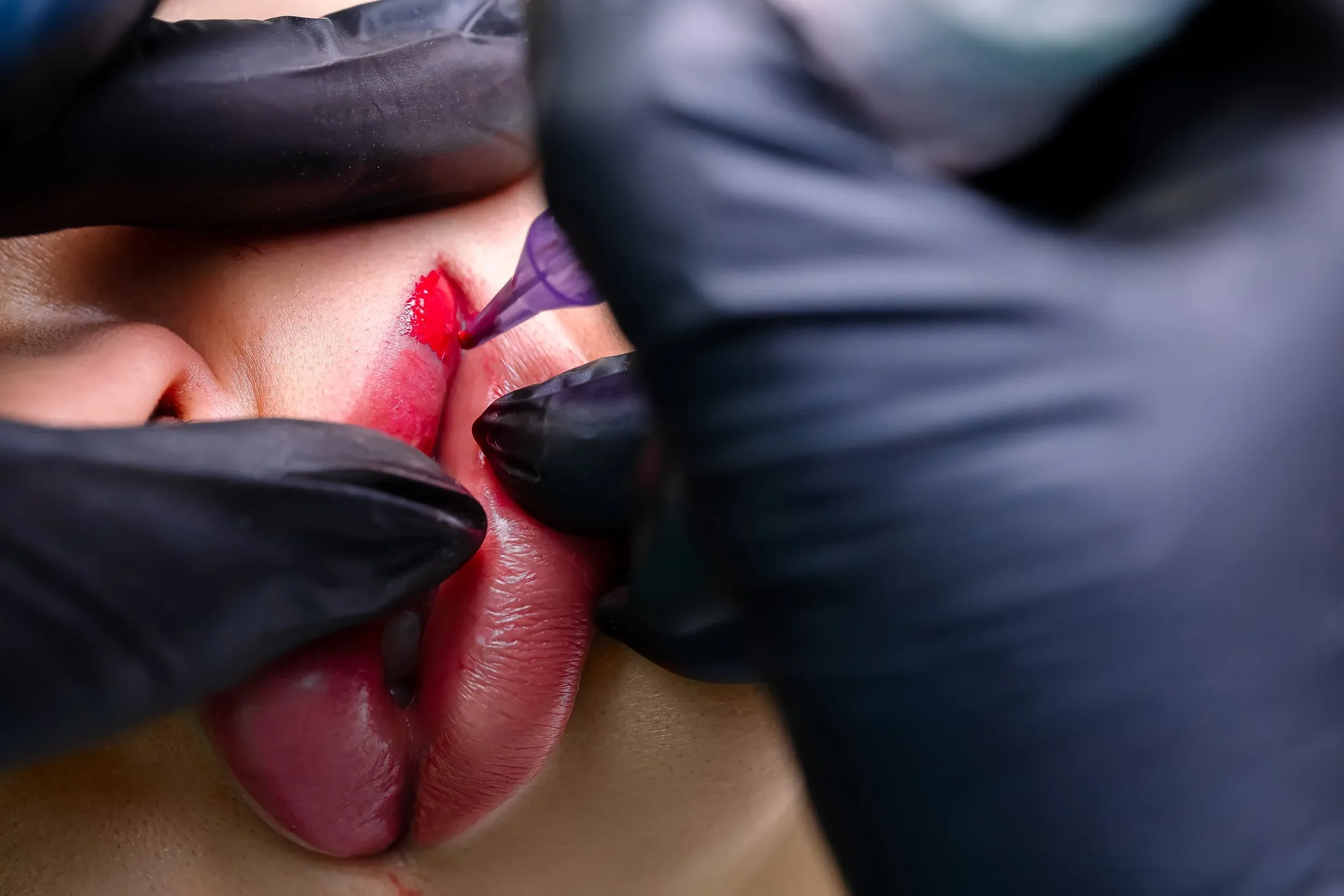 Lip blush application — permanent lip colour being applied in studio